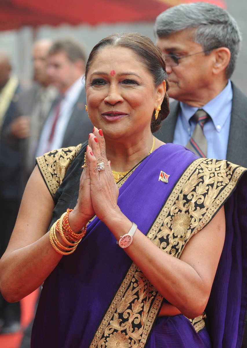 Then Prime Minister of the Republic of Trinidad and Tobago, Kamala Persad-Bissessar gestures towards media representatives during a welcome ceremonial at The Presidential Palace in New Delhi on Jan. 6, 2012.