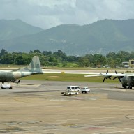 Workers at Piarco international Airport, Trinidad, load a Venezuelan military plane with food products on June 23, 2016, in the first airlift of goods to be taken to Sucre state, Venezuela, aimed at bringing relief to a critical food shortage in that country