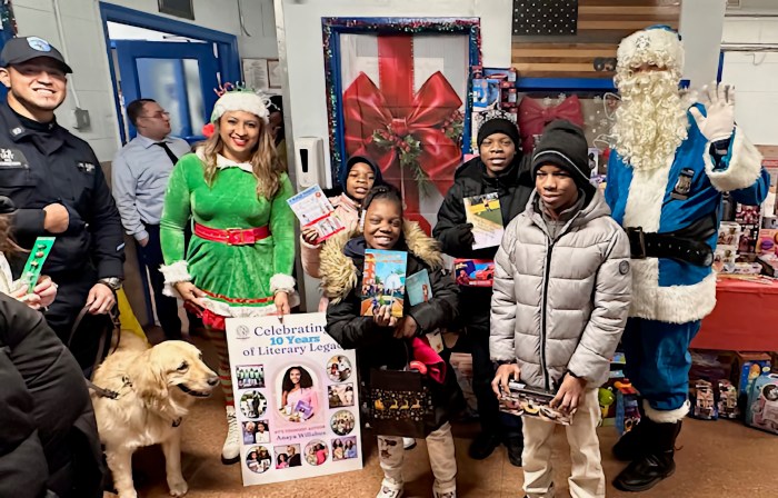 DOC Guzman with Onix, Dimple Willabus, the kids, and family members holding three of NY’s youngest author Anaya Lee Willabus’ books and Police Clause.