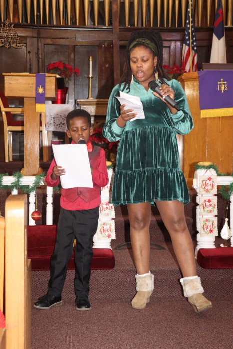 Mother and son duet: Densa Belony and her son, Daen Blemur, are enthralled with a song, “The Prayer.”