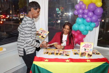 Dr. Ansha Clement signs the ‘Baby’s First Science: ABC’ book for Bernadette Cox.