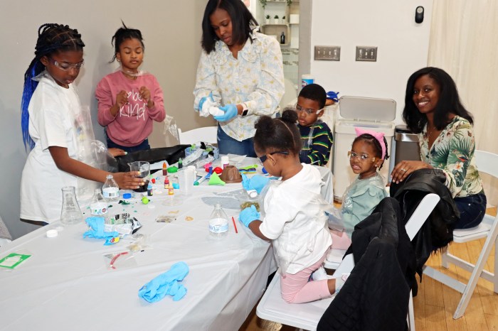 Teachers assist children with a science project based on Dr. Ansha Clement's book, 'Baby’s First Science: ABC.