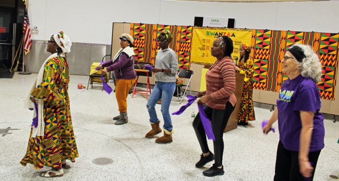 The audience broke into spirited dancing during an interactive Dance Workshop, led by Sister Arleen, at a pre-Kwanzaa celebration in partnership with Marine Park Alliance and Brooklyn College, as part of a Festival of Lights series at Carmine Community Center in Brooklyn.