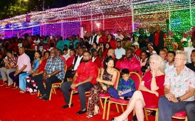 President of Guyana, Dr. Irfaan Ali, First Lady Ayra Ali, and sons, Sayd and Llan welcomed the Guyanese to the joyous celebration of Christmas Eve with music, song, and dance. The Frist Family, seventh and eighth from left, waved their arms to the music. Further left are Ministers Kwame McCoy, Charles Ramson Jr., Juan Edghill, Oneidge Walron, Mrs. Phillips (partly hidden, and Prime Minister Brigadier (Ret'd) Mark Phillips.