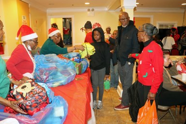 Members of the Family Life Ministry distribute gifts to children.