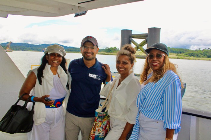 Caribbean New Yorkers pose with a tour guide of Panama Marine Adventures, Jose Manuel, second from left, during a sail through the Panama Canal.