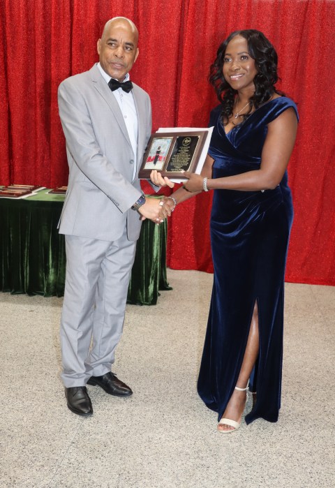 Eudene Mason receives Community Service Award from Grenada Consul General to New York Michael Brizan.