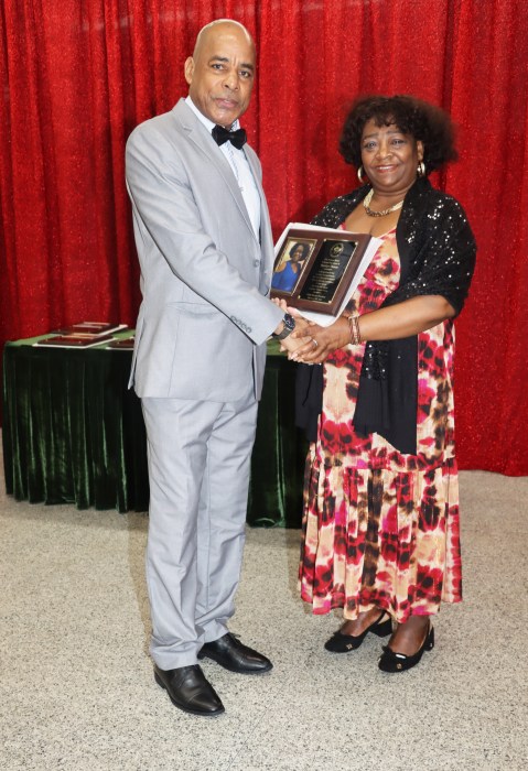 Grenada Consul General to New York Michael Brizan presents the Education Award to Hermelene Thomas.