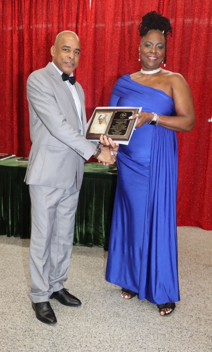 Grenada Consul General to New York Michael Brizan presents the Inspirational Motivator Award to Eugene McQueen.