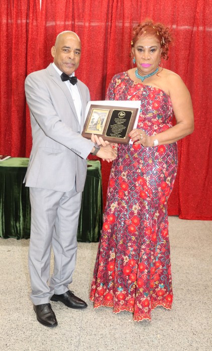 Grenada Consul General to New York Michael Brizan presents the Community Service Award to Beverly Hood.