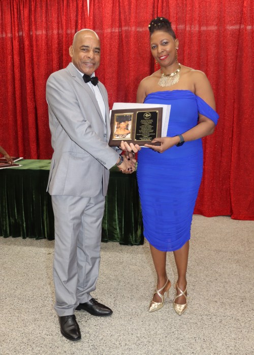 Grenada Consul General to New York Michael Brizan presents the Entrepreneur Award to Carolann Penny.