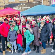 Keren Espinoza, center, surrounded by Help Us Help the World Foundation members and community leaders during the Christmas toy giveaway.