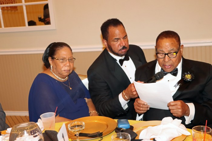 Dr. Paul Clement assists his dad, Martin Clement, as he reads his "Thank You" speech flanked by his wife, Margaret.