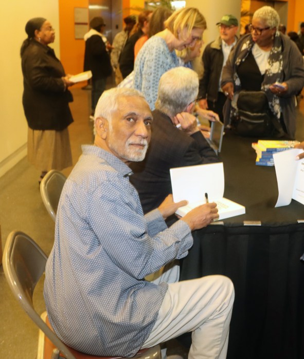 Frankie McIntosh signed a copy of his book at the launching ceremony at Brooklyn College in November 2024.