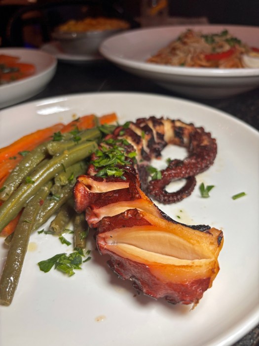 Grilled octopus, sautéed root vegetables, and a side of choice, a Djon Djon’s menu highlight.