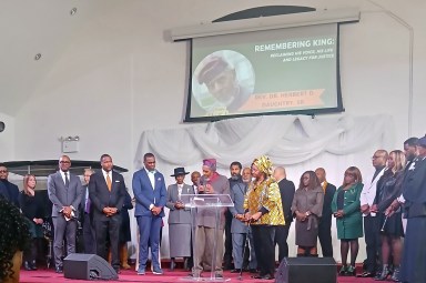 Members of the Clergy listen attentively as Rev. Dr. Herbert Daughtry, his wife beside him in the forefront, discussed the need for the legacy of Dr. Martin Luther King to continue at Alliance Tabernacle, on Clarendon Road.