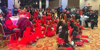 Children and their parents enjoy the holiday party hosted by Resorts World NYC and the NYPD.