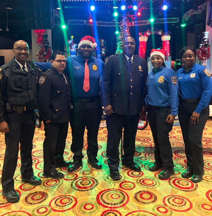 Chief Kevin Williams, center, poses with fellow NYPD officials at the holiday celebration.