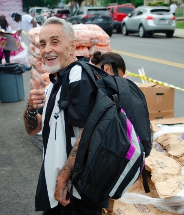 Swami Durga Das, founder of River Fund NY, participates in the organization's back-to-school giveaway project.