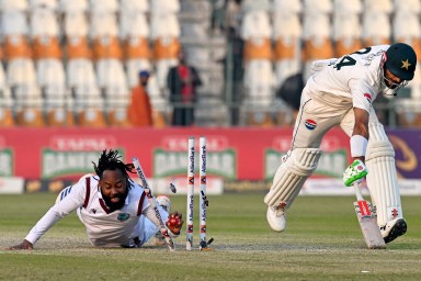 West Indies' Jomel Warrican (L) run out Pakistan's captain Shan Masood during the second day of the first Test cricket match between Pakistan and West Indies at the Multan Cricket Stadium in Multan on Jan. 18, 2025.