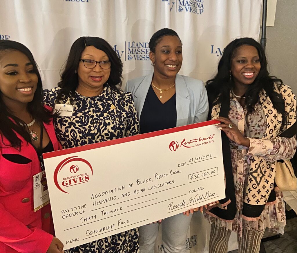 On the right, its Charlene Gayle, a member of the NYC Mayor Eric Adam’s Minority and Women-owned Business Enterprise (M/WBE) Advisory Council and the three other ladies on the left are members of the Resorts World NYC Gives holding a sign of a donation made towards the NYSABPRHAL scholarship program and the organization itself.