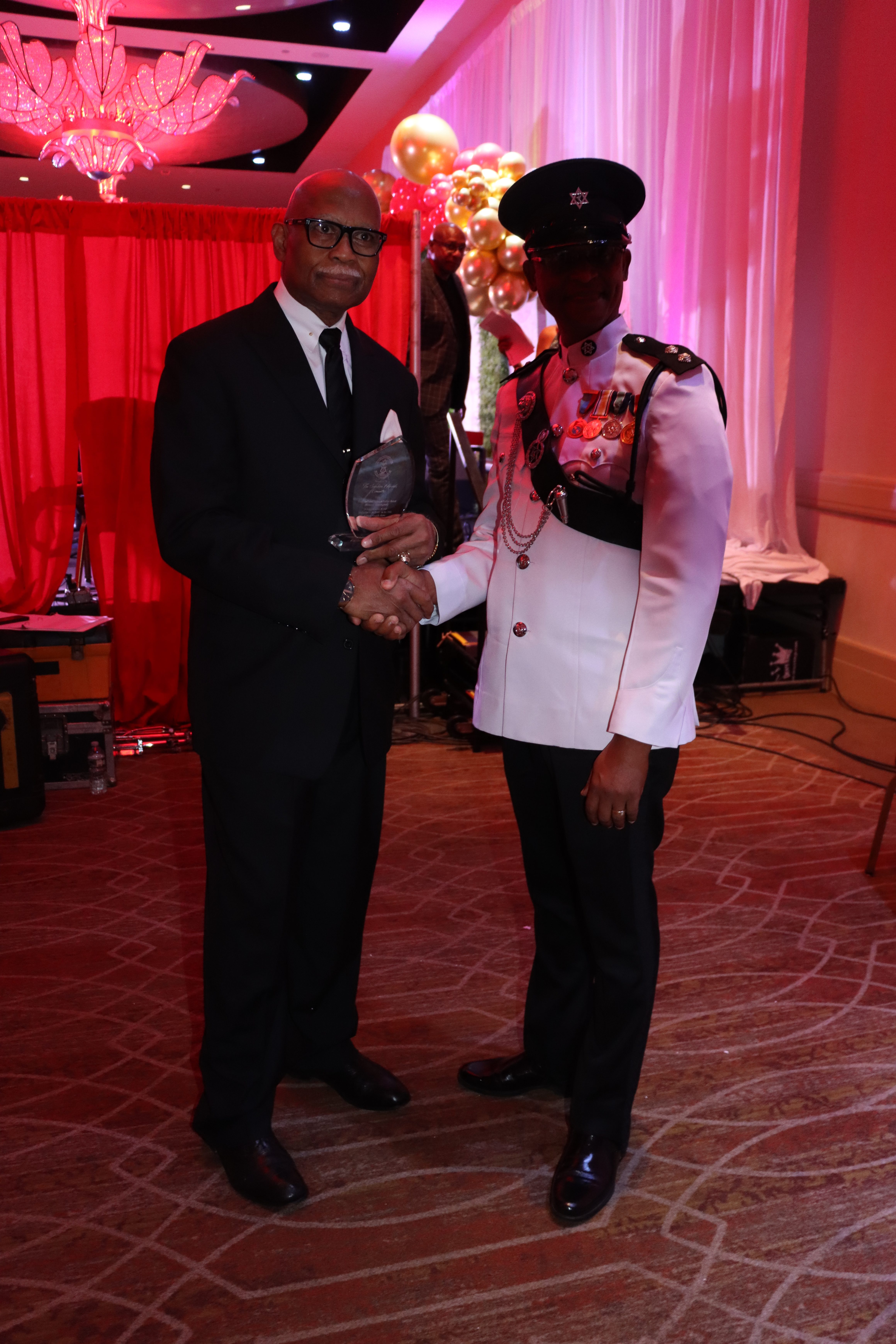 Gil Figaro, left, receives award from Acting Superintendent of the Trinidad and Tobago Police Service Wayne Guerra during the Sunshine Awards Gala in Newark, NJ in October 2024