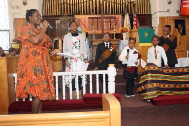 Sunday School Superintendent Jamaican Sis. Gail Murray leads Sunday School Students with a Black History Moment.