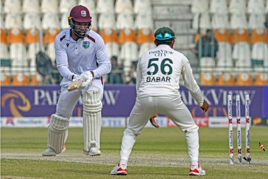 West Indies' Mikyle Louis (L) reacts after getting clean bowled by Pakistan's Sajid Khan during the third day of the first Test cricket match between Pakistan and West Indies at the Multan Cricket Stadium in Multan on Jan. 19, 2025.