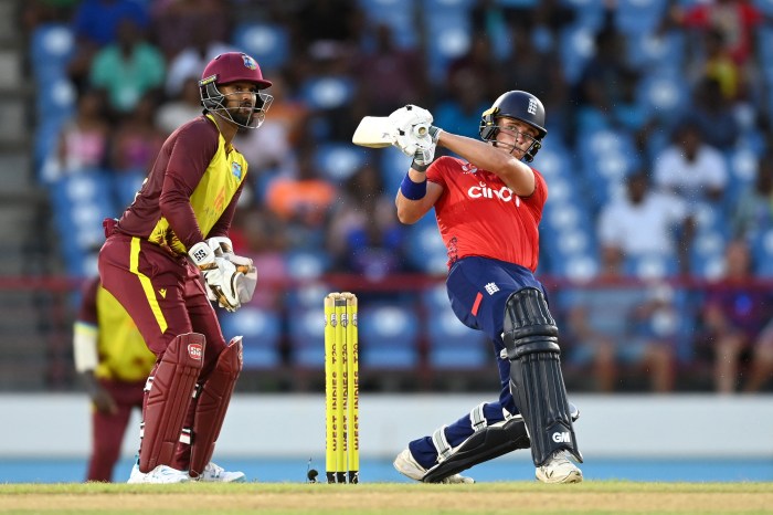 Jacob Bethell of England hits out for six runs watched by West Indies wicketkeeper Nicholas Pooran during the 4th T20 International between the West Indies and England at Daren Sammy National Cricket Stadium on November 16, 2024 in Gros Islet, Saint Lucia.