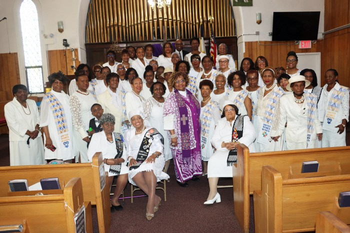 The Rev. Majorie E. Nunes, center, Pastor the Rev. Roger Jackson, at back, and United Women of Faith after 66th Anniversary Worship Service.