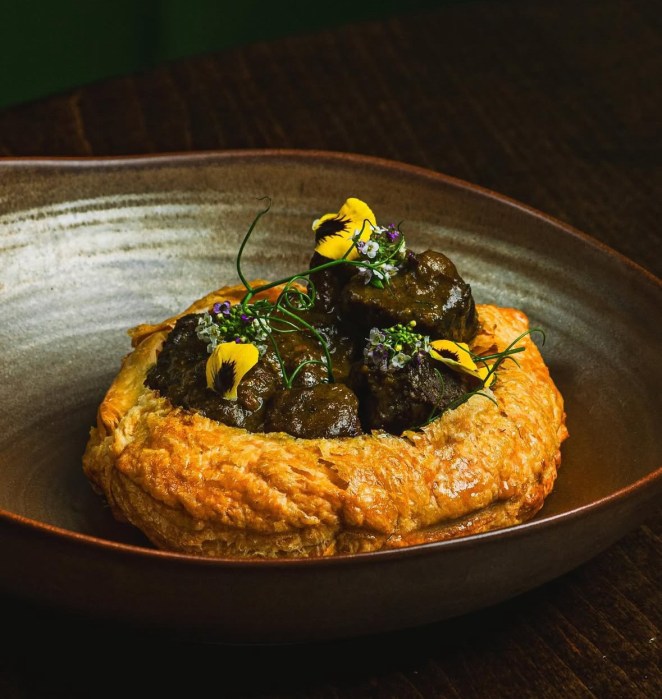 Goat Puff Pastry – A flavorful appetizer filled with curried goat juh and pimento seeds, offering a bold and aromatic start to the meal.