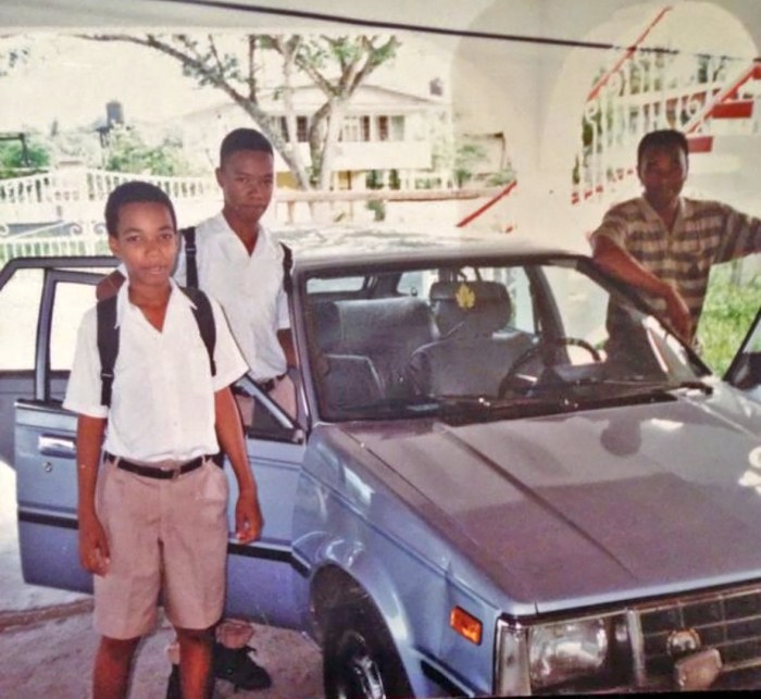 Detective Charles (left) poses with his father, a former Guyana police officer, and older brother during his teenage years in Georgetown, Guyana before leaving for school.